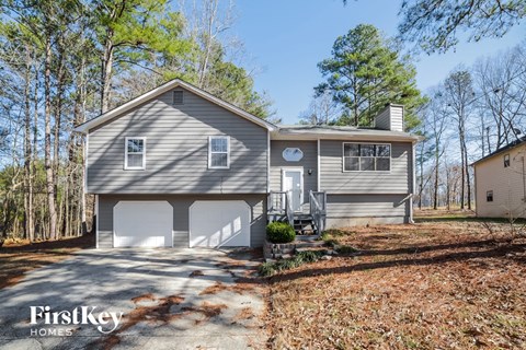 front view of a home with a garage and a driveway